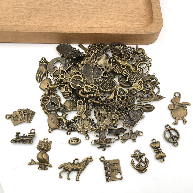 100個の混合レトロなイヤリングのネックレスのアクセサリーの古い青銅の小さいペンダントのdiy材料の合金の部品は鏡にまたがります。|undefined
