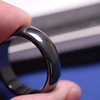 Magnetic glossy black fashionable ring, on index finger