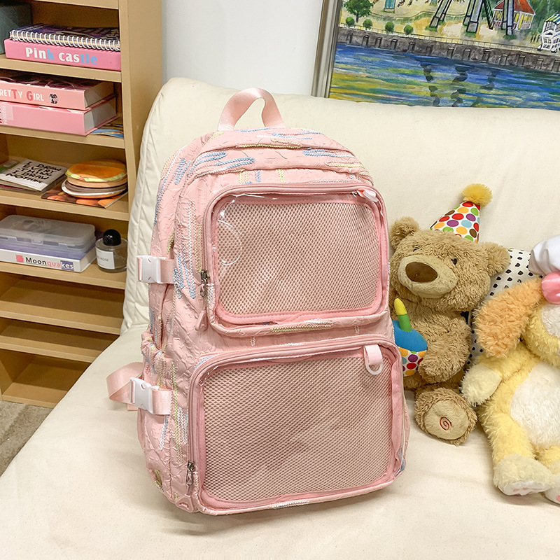 En la nueva mochila femenina 2025, la nueva chica tiene una gran capacidad de dibujos animados, estudiantes de secundaria, mochilas llenas de bolsos portátiles.