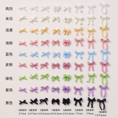 蝶結びのネイルアクセサリーのミックスモデルのミニリボンと黒と白の立体純色樹脂のネイルアートのアクセサリー