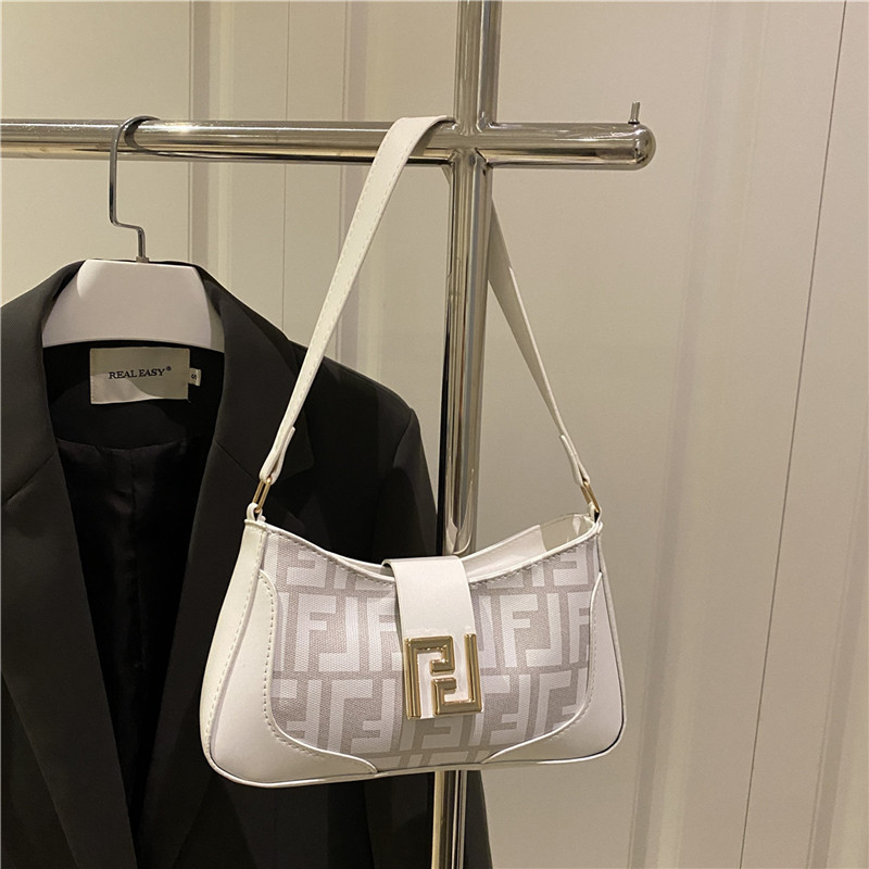 Bolsa de mitad de mes caliente 2025 nueva mujer color transfronterizo bolso de hombro brazalete de alto nivel nicho bolso de diseño