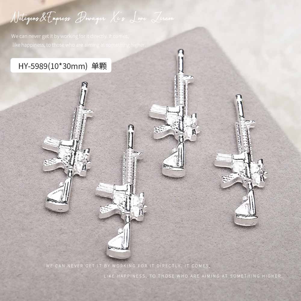Europa y los Estados Unidos en línea con diamantes AK armas de manicuría joyas de simulación de personalidad tridimensional armas de fuego decoración de uñas al por mayor