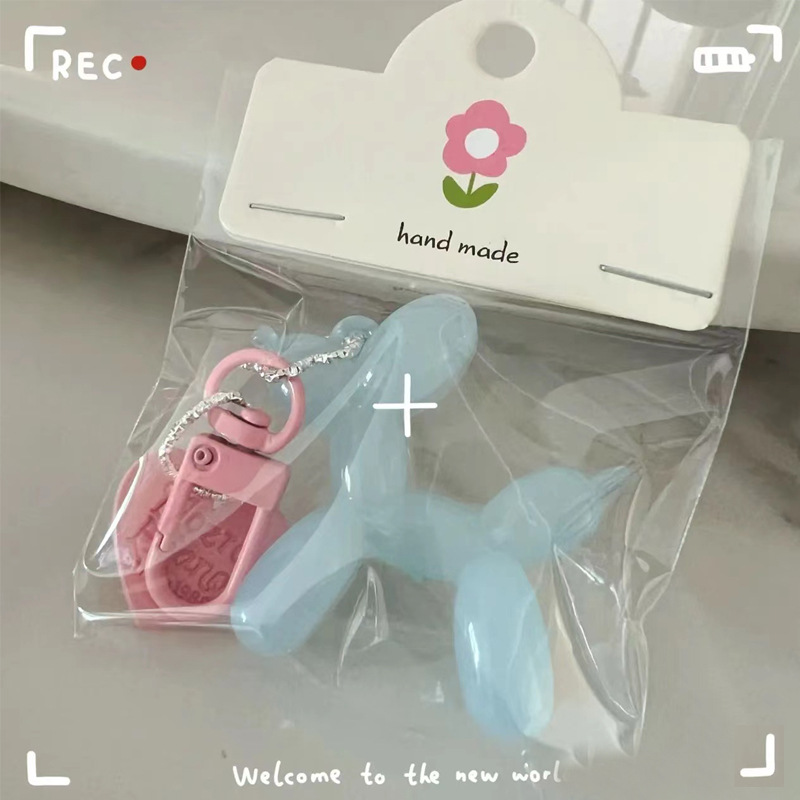 Pequeño Libro Rojo mismo lindo jalea globo láser perro llavero colgante colorido cachorro de dibujos animados teléfono llavero