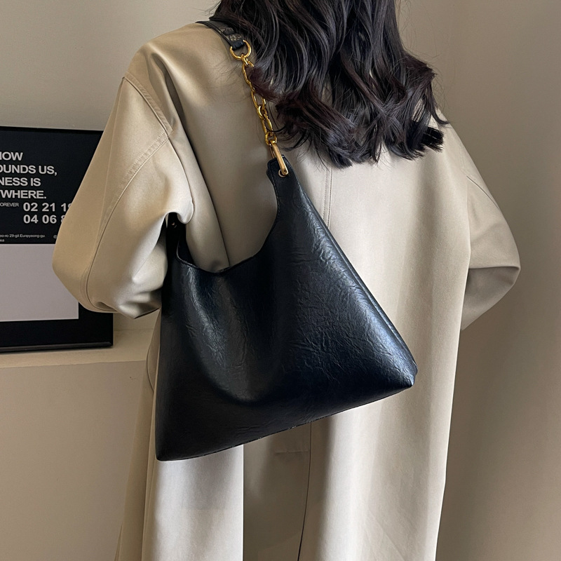 Bolsa de mano relajada coreana para mujeres 2025 nuevo retro versátil viaje bolso de hombro bolso de cubo debajo de la axila