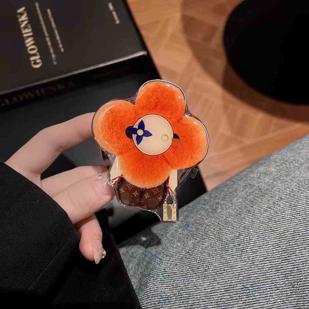 新型高級マグネットスタンドマグネット式携帯ケース通用太陽花マグネット式エアバッグスタンドはおしゃれで豪華です。