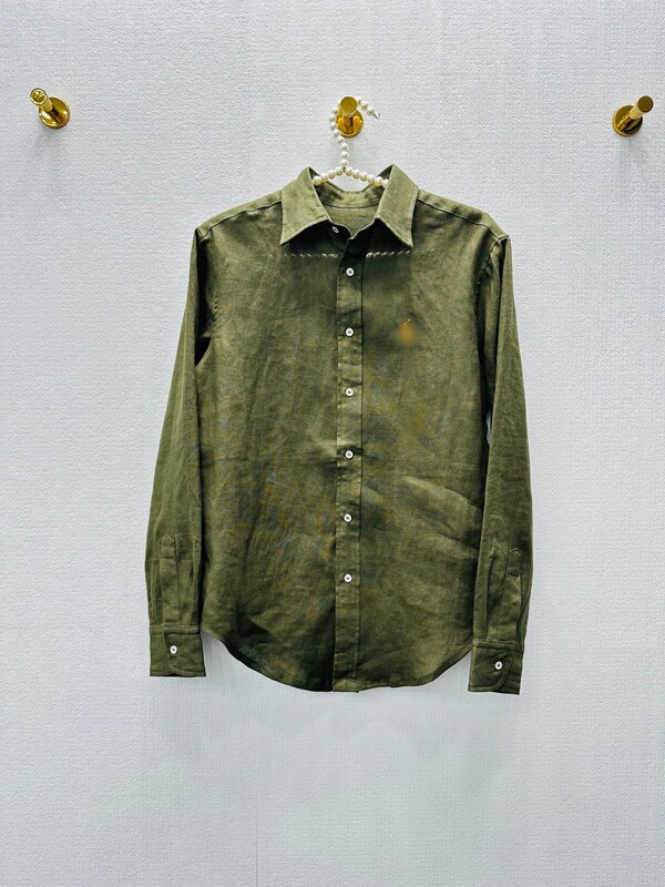 Olive green linen long-sleeved shirt for women, featuring a vintage, distressed look, embroidered details, and a unique, loose-fitting, casual design Olive green linen long-sleeved shirt for women, featuring a vintage, distressed look, embroidered details, and a unique, loose-fitting, casual design