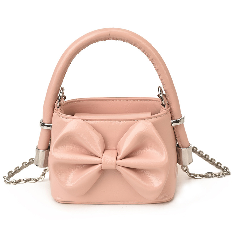 Nuevos bolsos de cadena coreanos para niños y niñas, bolsos de mini arco, bolsos de mano para niños, bolsos de comercio exterior transfronterizos