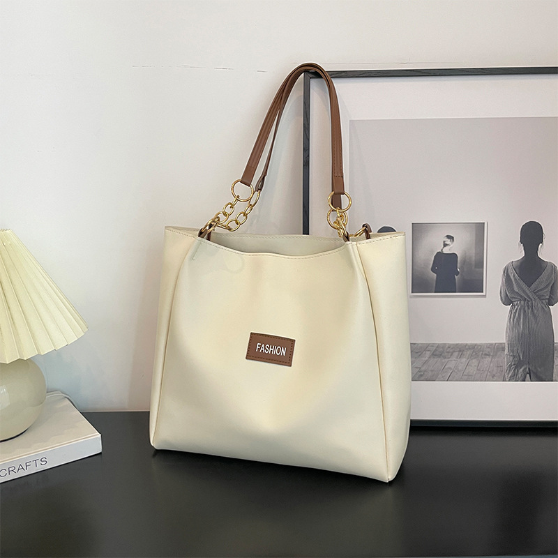 Este año, la textura Popular de gran capacidad tote paquete para mujeres 2024 nuevo paquete de clases para estudiantes de ocio de moda de moda paquete de cercanías