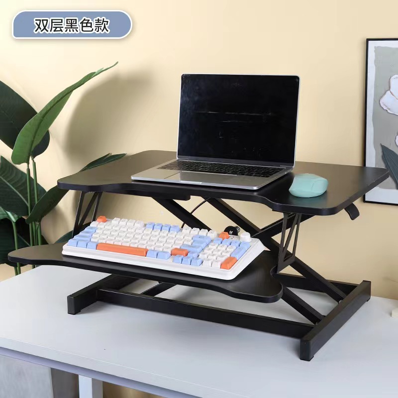 気動机の上のコンピュータの机は立式の事務室の台の上に立って高くなるノートの折り畳みの机で机を昇降することができます。