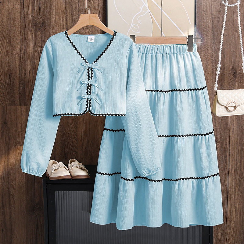Ropa para niñas de comercio exterior europeo y americano, nueva colección primavera 2026, top de manga larga con lazo y falda de encaje para Amazon transfronterizo.