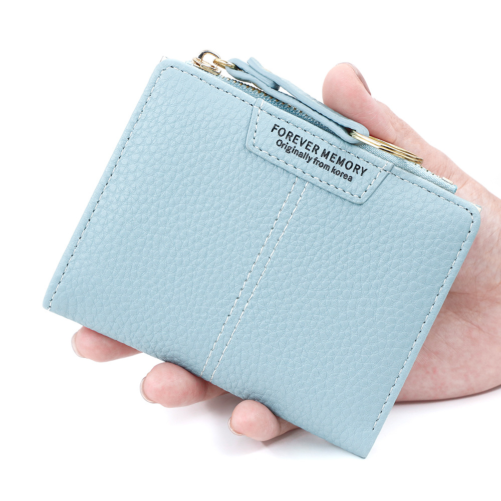 Versión coreana de la nueva billetera corta para mujer, llavero simple, billetera de monedas, billetera de dos pliegues para estudiantes al por mayor