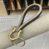 Black cowhide + brass hardware