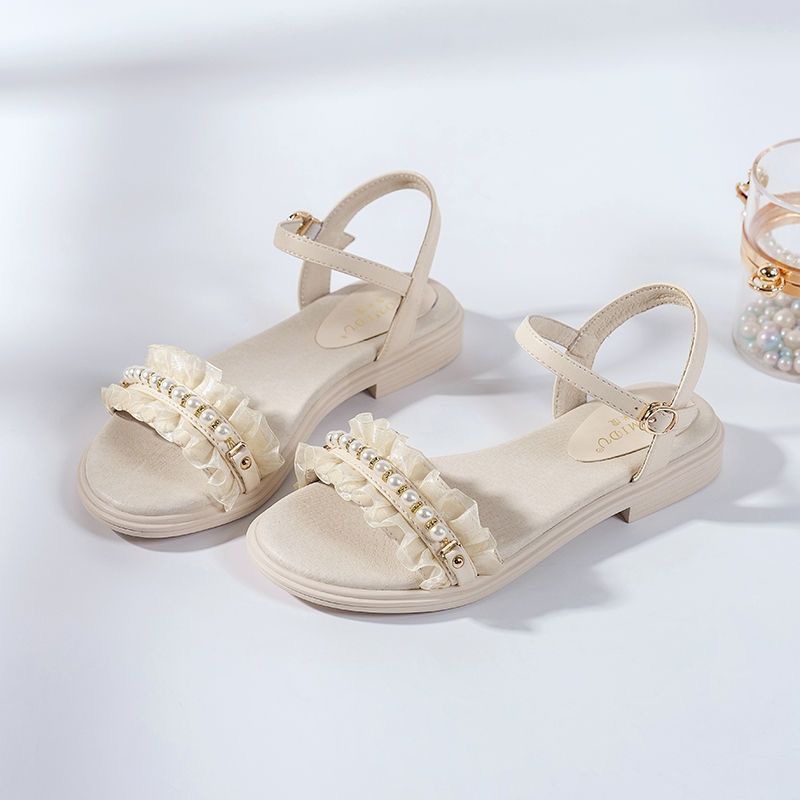 Sandalias de playa de viento de hadas 2025 verano nuevo estilo con falda, estilo de estudiante plano, sandalias de perlas de una sola palabra, mujer