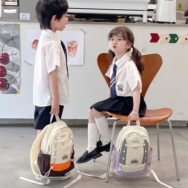 Mochila de moda coreana para niños y niñas, mochila de alta capacidad para estudiantes de escuela primaria, nueva mochila para niños con cuerda extranjera.