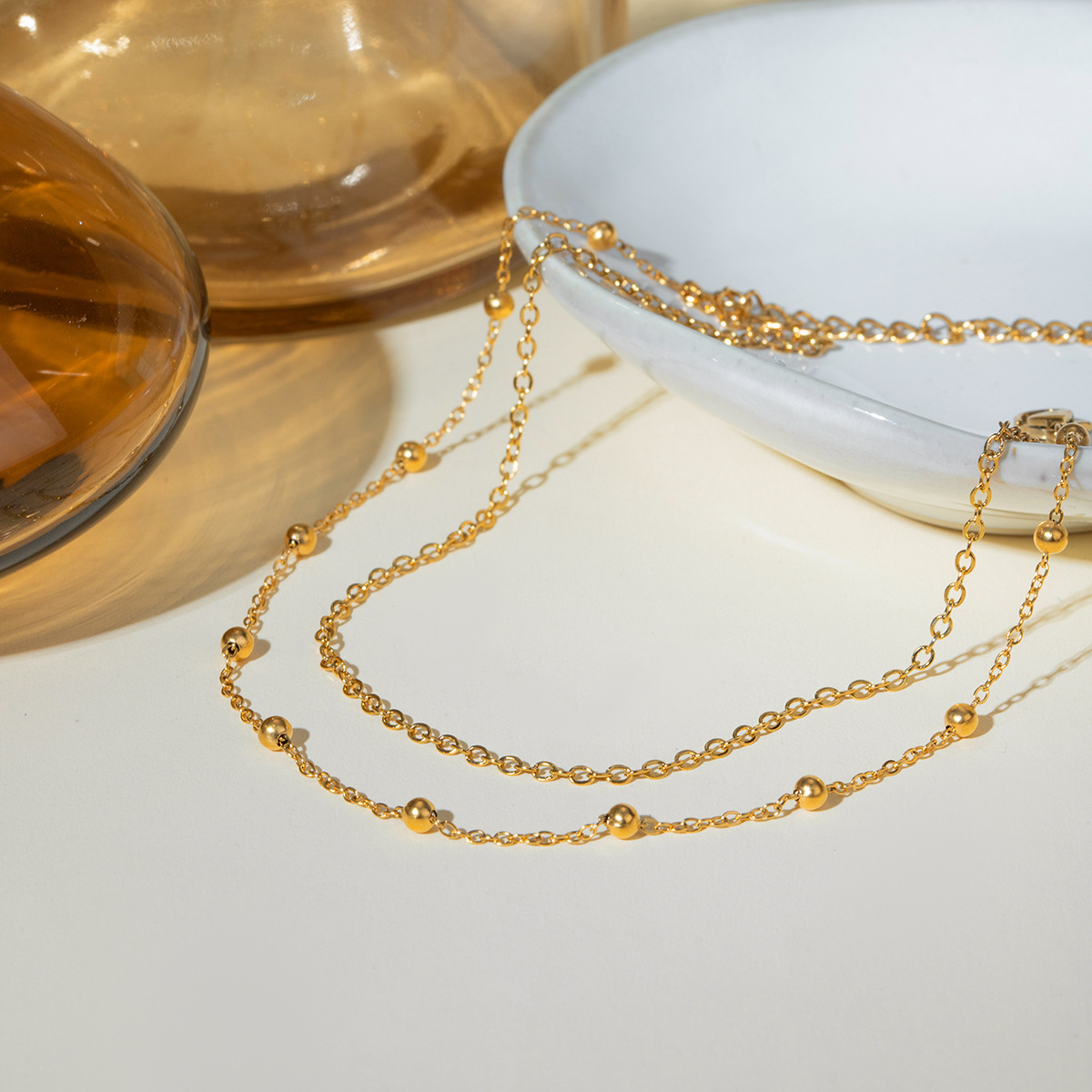 Accesorios de verano nuevos nichos europeos y estadounidenses de moda versátil 18k oro acero inoxidable doble cadena de bolas joyerías de tobillas para mujeres