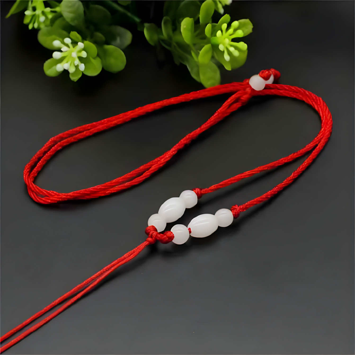 Add white rice beads and red thread
