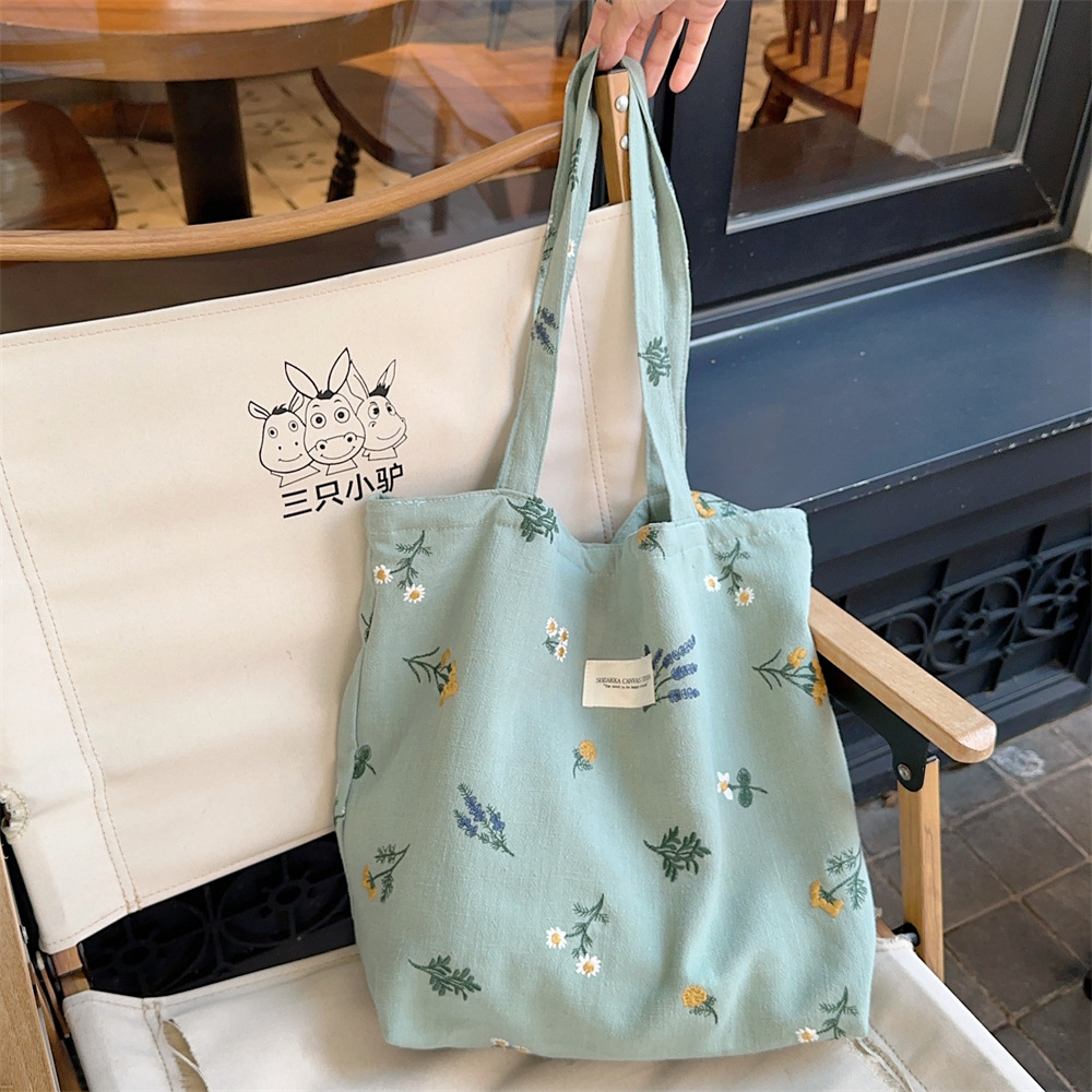 310231 estilo francés nuevo hombro bolsa de algodón ins estilo retro pequeña flor bordada bolsa de cosméticos bolsa de lona portátil