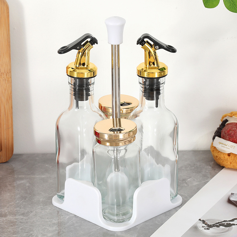 Botella cuadrada de lujo ligera de cuatro piezas Botella de condimento de vidrio de cocina Olla de aceite Tanque de sal a prueba de humedad Tarro de condimento Botella giratoria
