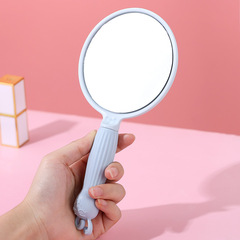 Adorable cartoon handheld makeup mirror, portable and compact, suitable for female students, with a handle for easy grooming, a beauty mirror for cosmetics and skincare.