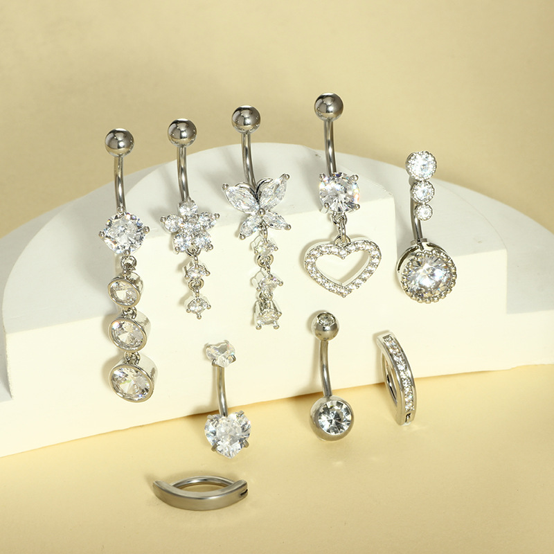 9つのステンレスのへその輪の組み合わせの銅はジルコンの水滴のへその輪の円形のハート型のへその釘のメーカーの現物を入れます。