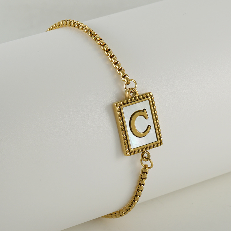 Nuevo europeo y americano transfronterizo de acero inoxidable 26 letras inglesas Shell pulsera personalidad todo partido titanio acero 18K cremallera