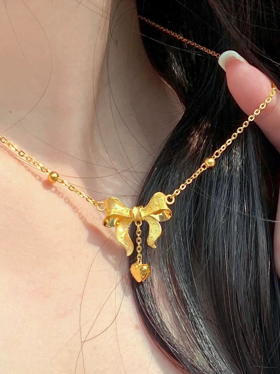 Collana con pendente a cuore e fiocco con nappe dorata_voghion.com