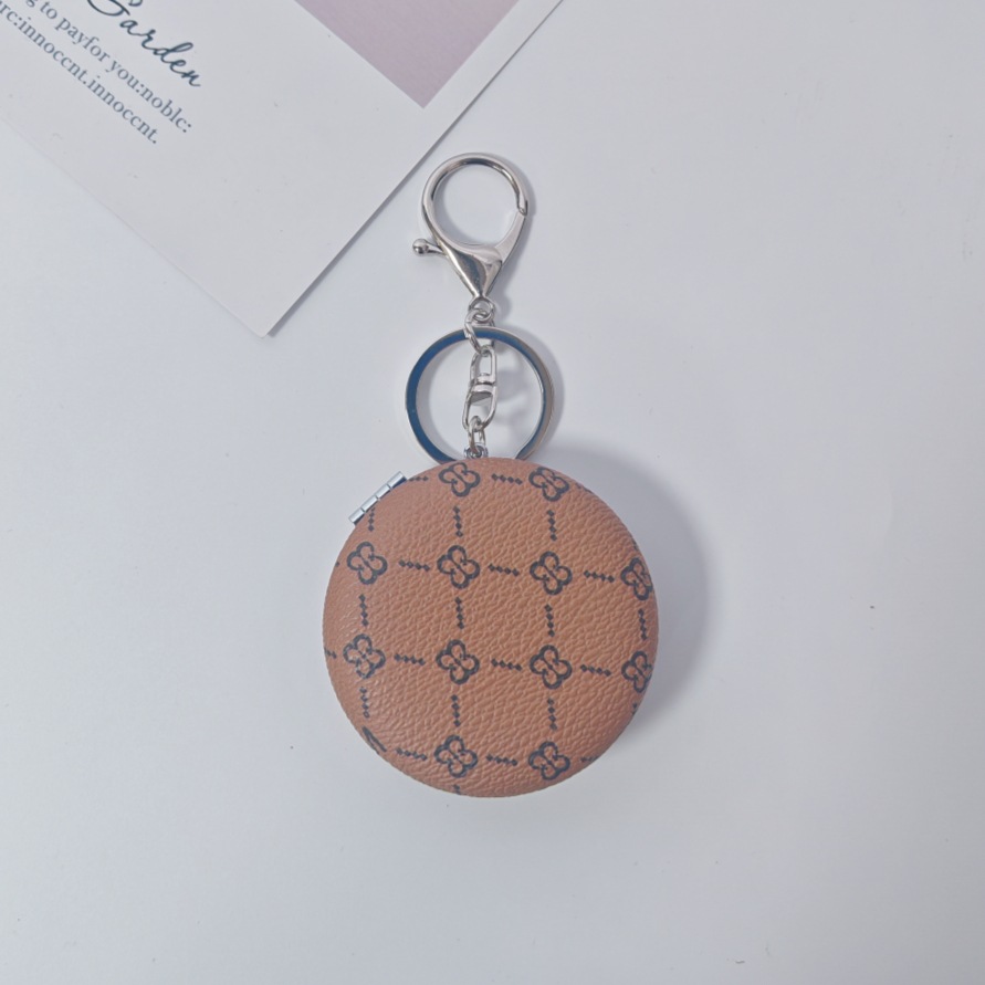 Bolsa de espejo popular en línea colgante de lujo ligero llavero portátil espejo de maquillaje transfronterizo colgante de bolsas de espejo doble cara