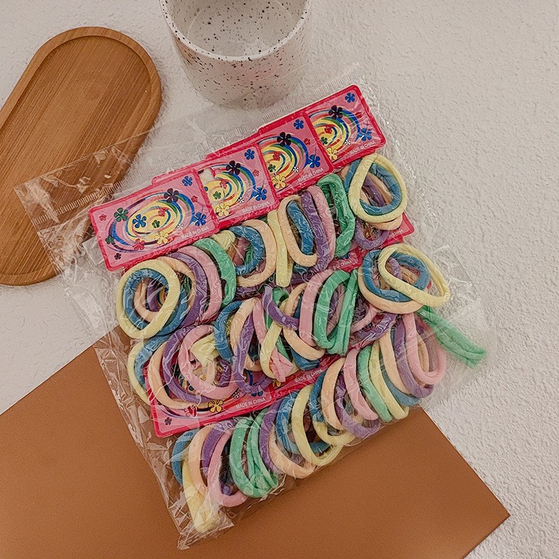 100-pieza de alta elástica sin costura toalla anillo de color Banda de pelo cuerda de pelo de color caramelo banda de goma cubierta de cuero cuerda de pelo al por mayor