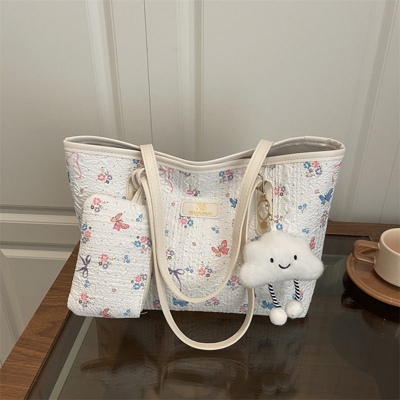 2026 flores coreanas mariposas de gran capacidad de viaje de primavera nueva moda moda extranjera bolso de hombro
