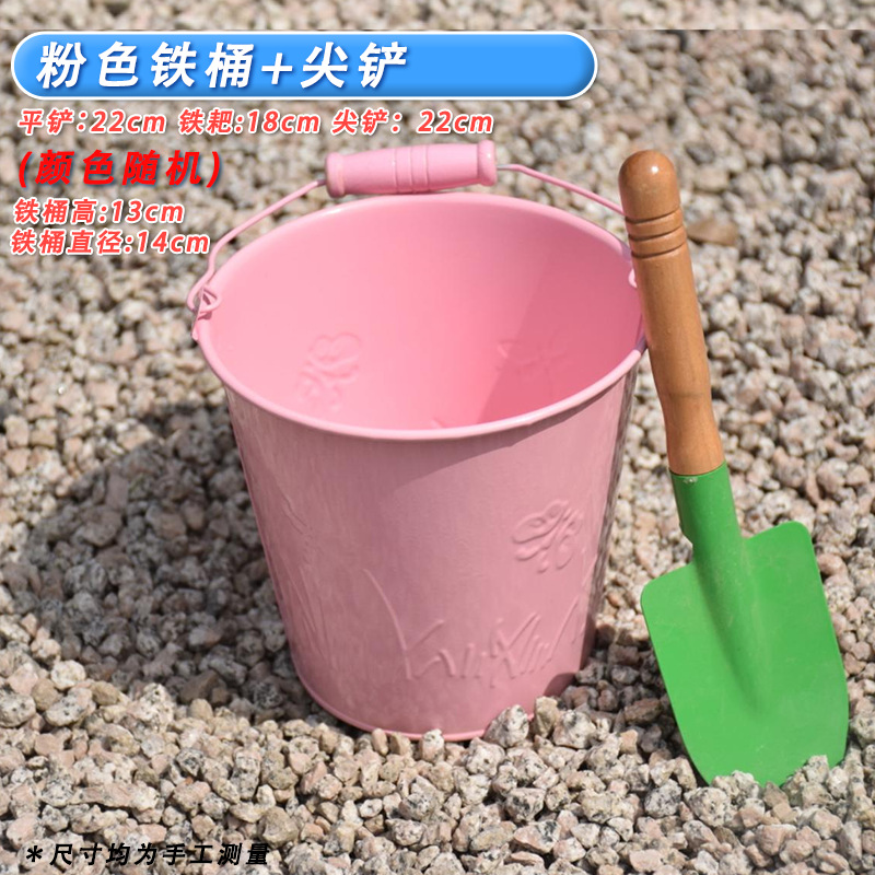 One pink iron bucket + one small pointed shovel