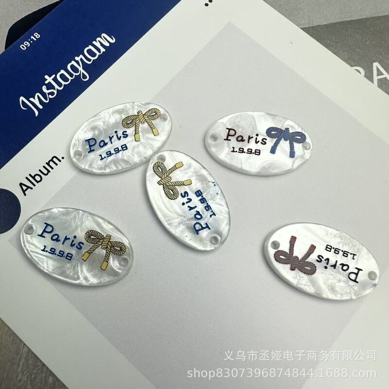 现货仿贝树脂商标吊牌字母椭圆蝴蝶结衣标高端百搭装饰纽扣60款|undefined