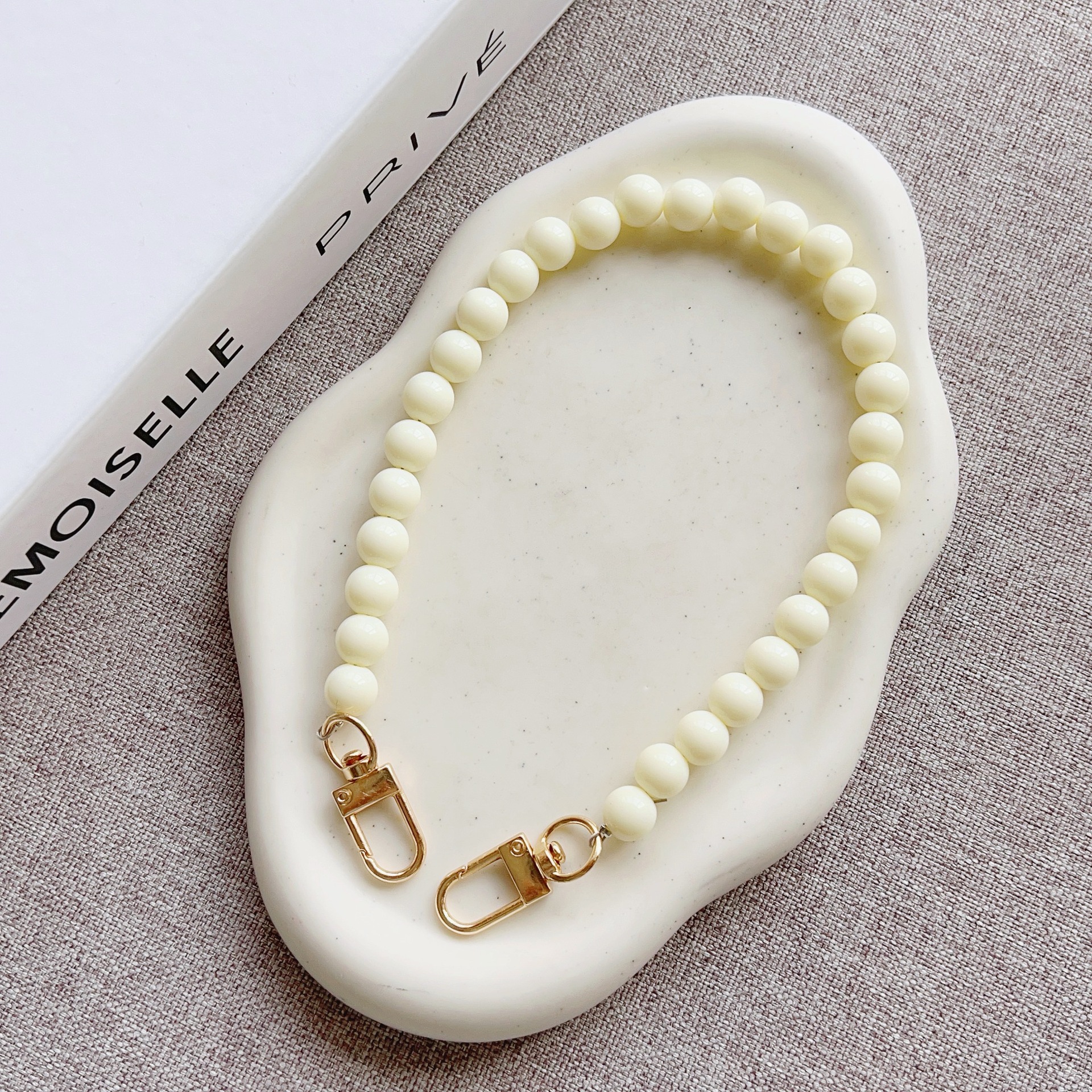 Nuevo estilo japonés y coreano cadena de cuentas de color sólido pulsera corta llavero bolsa de accesorios de cadena de perlas de todo fósforo cordón transfronterizo