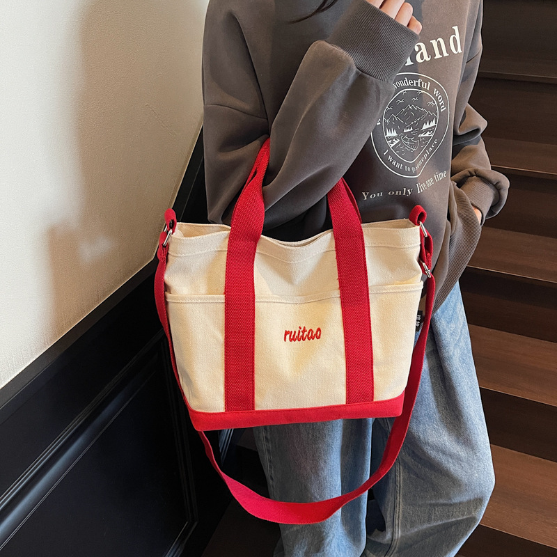 Bolso Tote de moda coreana 2025 verano nuevo estilo bolso de hombro estilo universitario bolso de mensajero de lona de color de contraste mujer