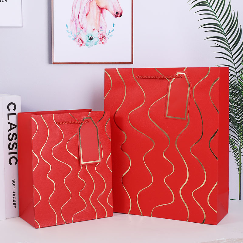 Nueva bolsa de regalo de estampado en caliente en relieve de línea ondulada, comercio exterior, bolsa de papel más vendida transfronteriza, tienda de regalos, supermercado, bolso al por mayor