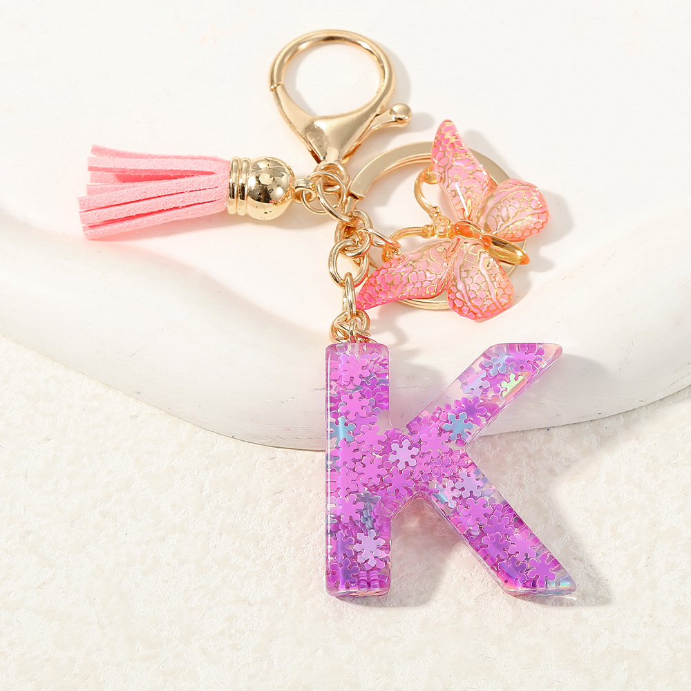 Nuevo color púrpura claro mezcla de polvo brillante letras inglesas resina llave colgante estilo simple mariposa borda colgante