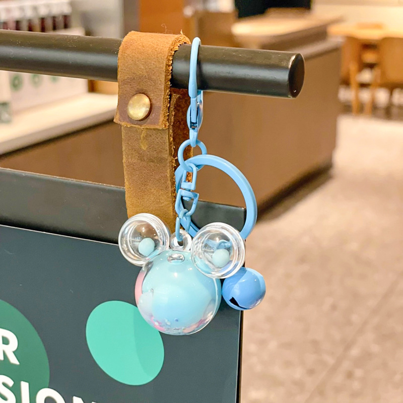 Caricatura en aceite líquido arena flotante botella mochila llavero delicado colgante accesorios accesorios máquina de muñecas pequeños regalos al por mayor