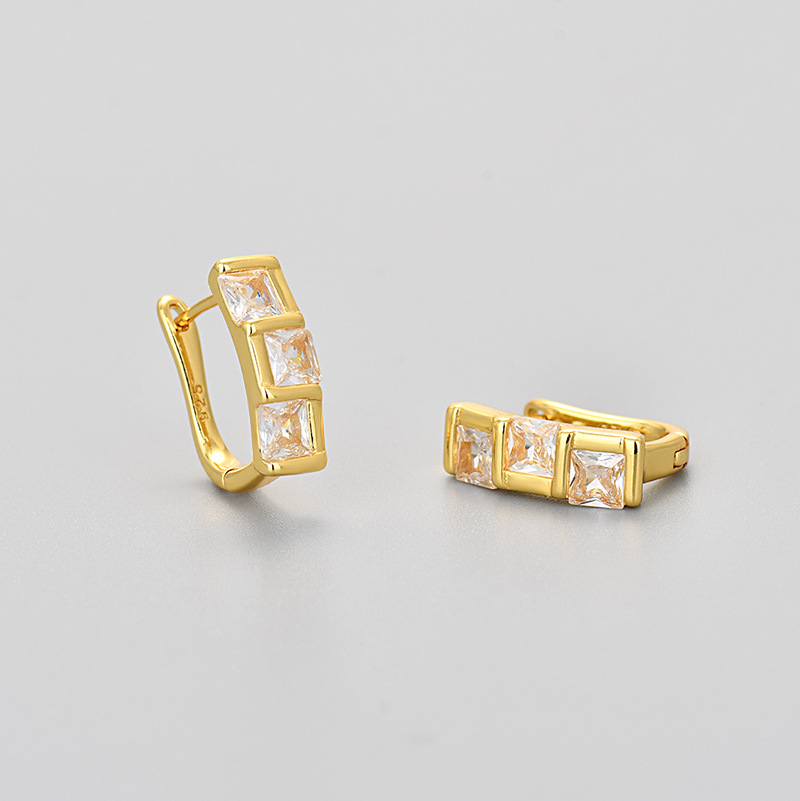 Square golden earrings with zircon