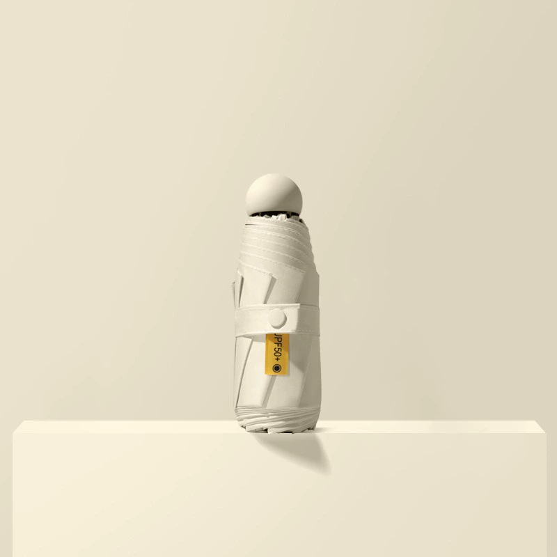 50% de descuento paraguas de cápsula de seis huesos paraguas de Sol de doble uso pequeño paraguas de bolsillo portátil simple pegamento negro paraguas de protección solar al por mayor