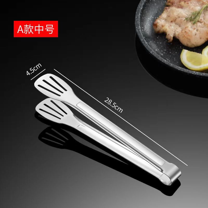 ステンレスの食品は台所の焼肉を挟んでステーキを焼きます。|undefined
