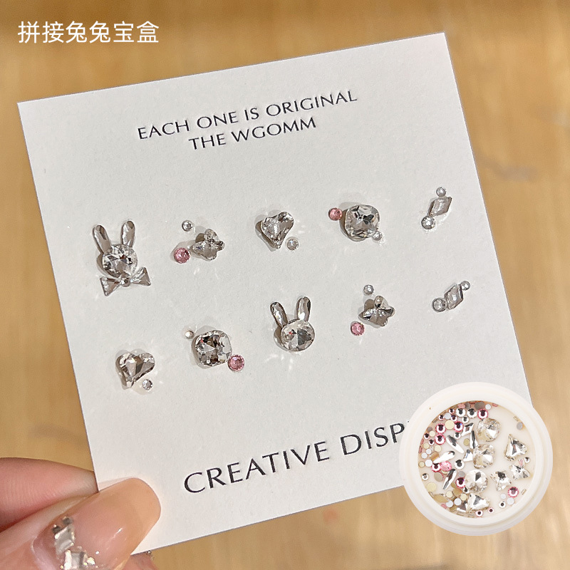 Desgaste de la celebridad en línea paquete de material de uñas caja del Tesoro japonés accesorios de uñas corazón torcido Mariposa Super Flash accesorios de uñas de diamante en forma especial
