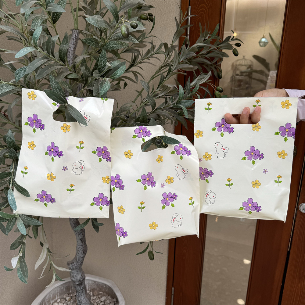 化妆礼品饰品塑料小手提袋子服装店用包装购物带卡通可爱四指批发