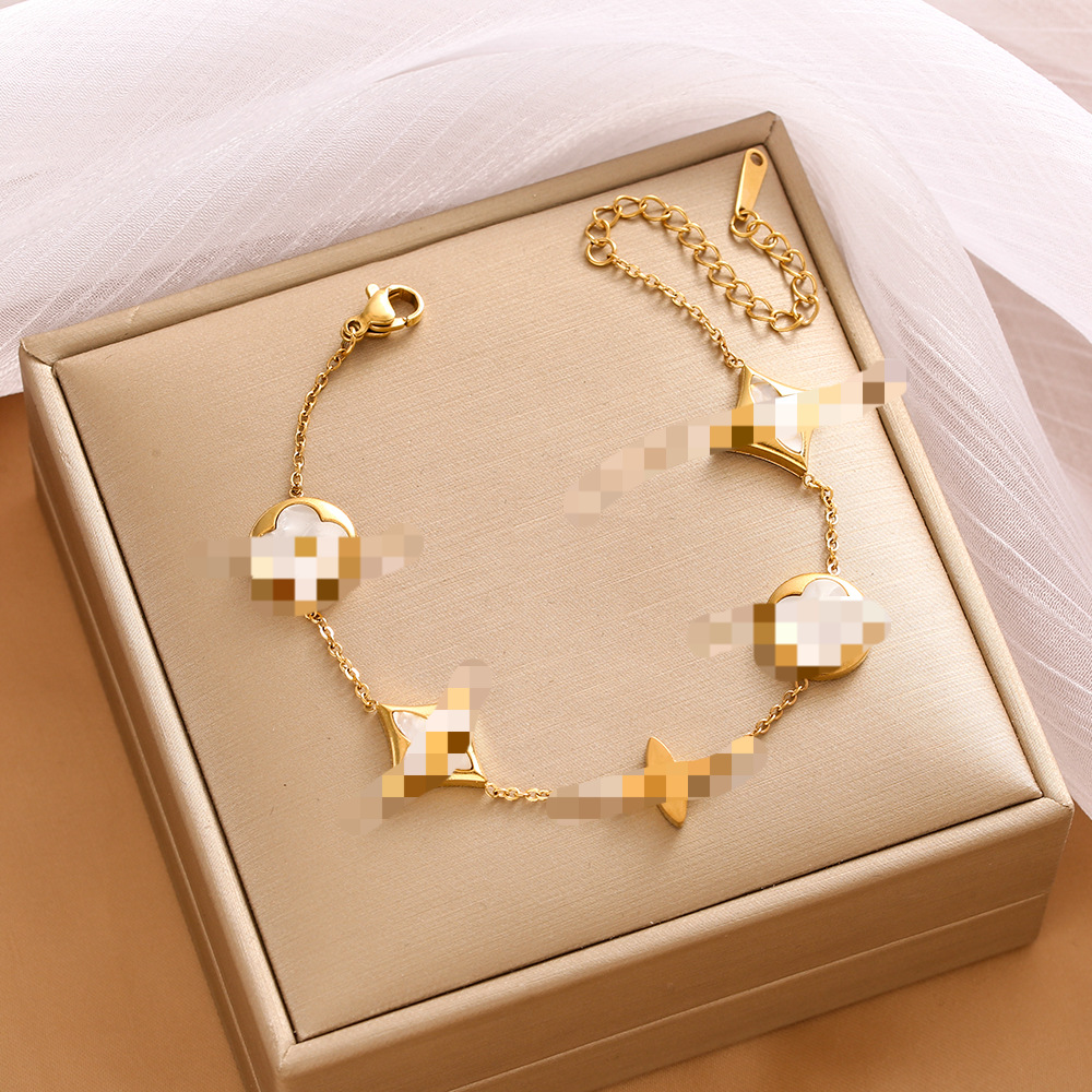 Pulsera de trébol de acero titanium vendedora caliente transfronteriza europea y americana con incrustaciones de concha pulsera colgante pulsera de diseño avanzado sin desvanecimiento al por mayor