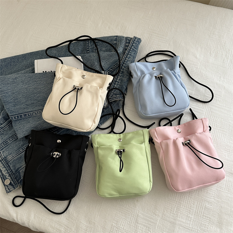 Bolsos de teléfono móvil de viento minimalistas para mujeres japonesas y coreanas bolsos de lona ligeros de cuerda de dibujo mini multifuncional bolsos de cambio de hombro