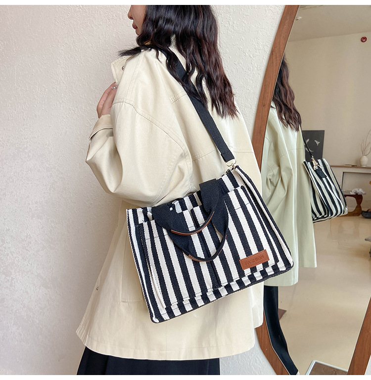 Popular striped canvas 2024 new commuter large capacity casual fashion personalized hand-held crossbody tote women's bag_voghion.com
