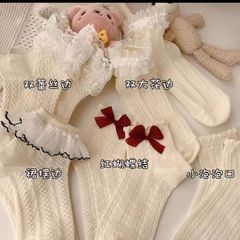 乳白色の蝶結びの花の縁の靴下の子供のかわいいロリータの日系jkレースのストッキングのlolitaは汗の中でストッキングを吸います。