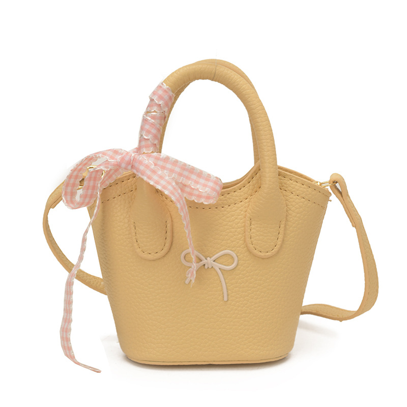 Nuevo bolso para niños coreano simple color sólido bolso de cubo para niños y niñas lindos arco mini bolso de mano bebé