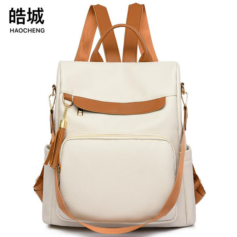 2024 nuevas damas casuales de cuero suave mochila antirrobo moda borla color de contraste mochila de viaje de gran capacidad al por mayor