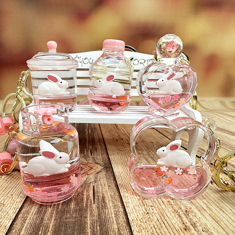 Colgante de llavero de conejo de botella de arena rosa, muñeca flotante creativa, decoración de mochila para niña, regalo exquisito para pareja
