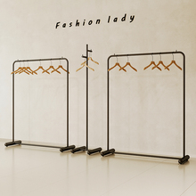 服装店简约铁艺黑色落地挂衣童装陈列奶白色女装店展示