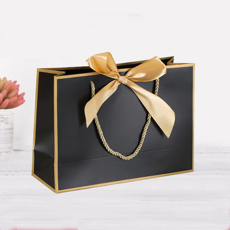 Bolsa de regalo de lazo Bolsa de papel Bolsa de embalaje de ropa Bolsa de cosméticos al por mayor Bolsa de compras Bolsa de mano con logotipo impreso